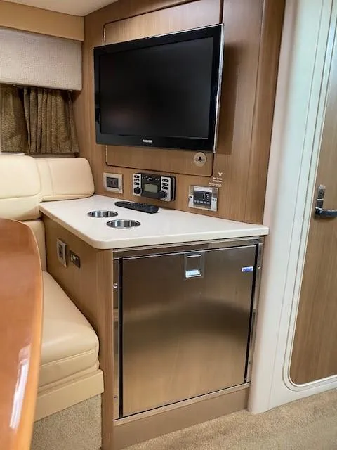 Slide: The Image of 2012 Formula 350 Sun Sport interior with TV, fridge, and seating area. - 18