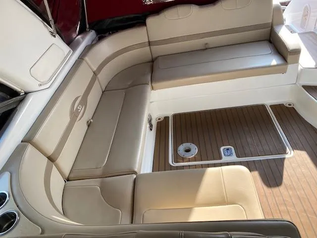 Slide: The Image of 2012 Formula 350 Sun Sport boat interior with beige seating and wood flooring. - 24