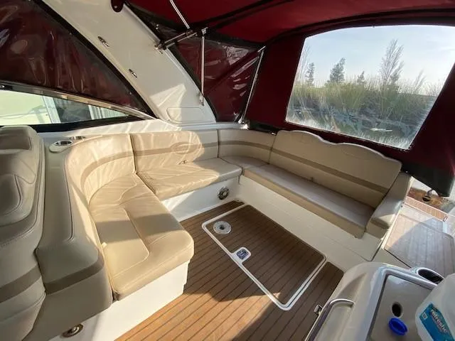 Slide: The Image of 2012 Formula 350 Sun Sport boat interior with beige seating and wood flooring. - 26