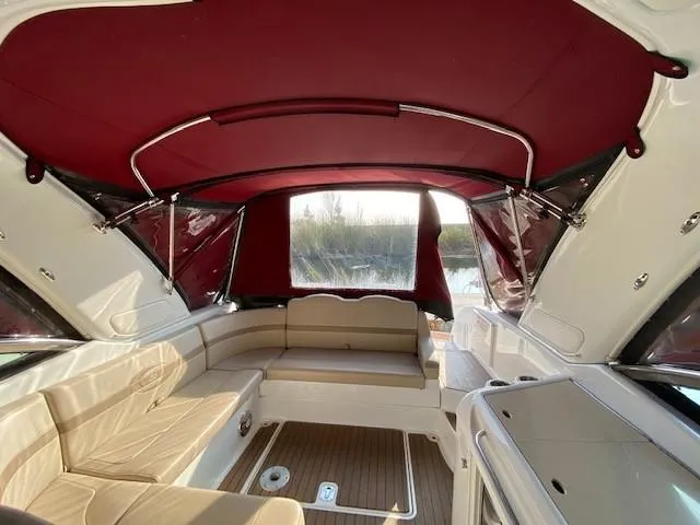 Slide: The Image of Interior of a 2012 Formula 350 Sun Sport boat with red canopy and beige seating. - 27