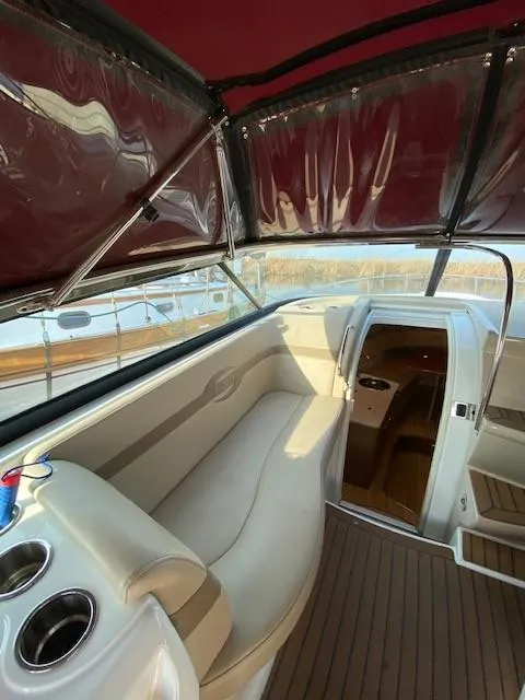 Slide: The Image of 2012 Formula 350 Sun Sport boat interior with beige seating and wood flooring. - 28