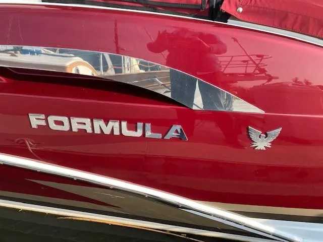 Slide: The Image of 2012 Formula 350 Sun Sport boat with red exterior and chrome accents. - 5