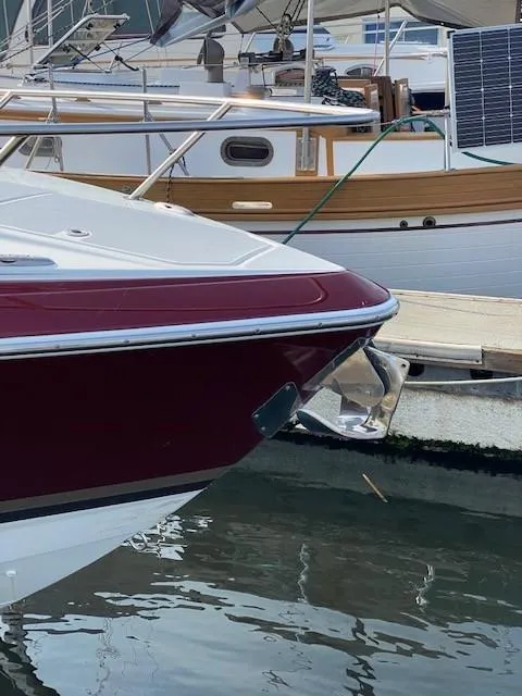 Slide: The Image of 2012 Formula 350 Sun Sport boat docked in marina, featuring sleek maroon and white design. - 6