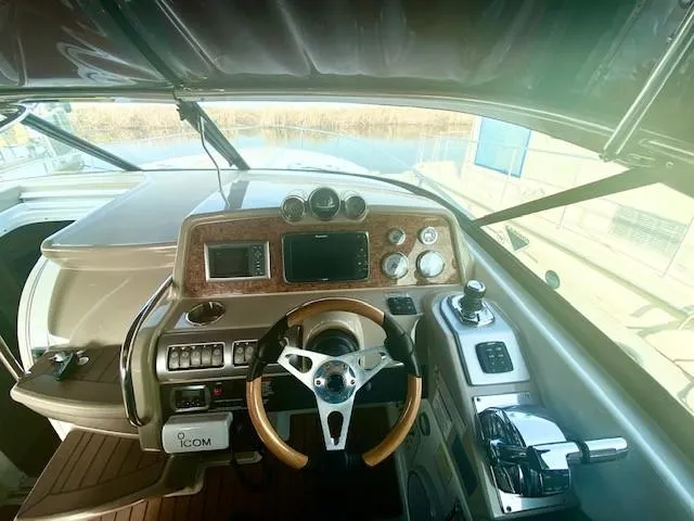 Slide: The Image of 2012 Formula 350 Sun Sport boat dashboard with steering wheel and control panel. - 7