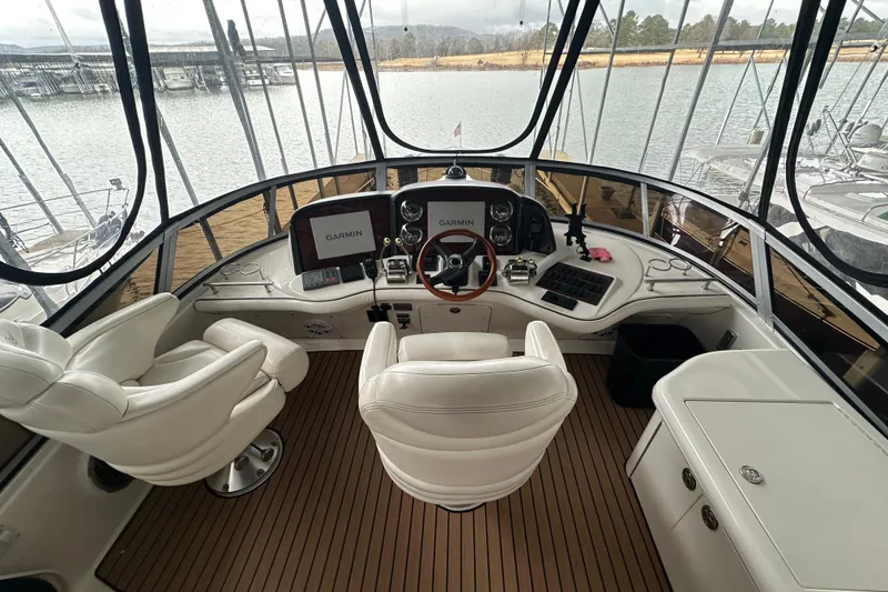 Slide: The Image of 2005 Sea Ray 420 Sedan Bridge helm with Garmin navigation, luxurious seating, and panoramic views. - 10