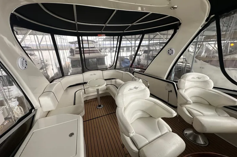 Slide: The Image of Luxurious interior of 2005 Sea Ray 420 Sedan Bridge with plush seating and panoramic windows. - 12