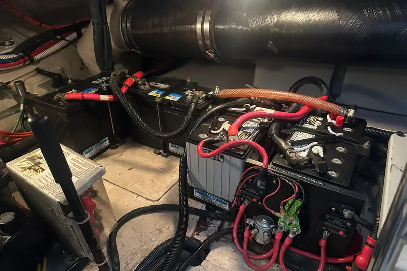 Slide: The Image of Engine room of 2005 Sea Ray 420 Sedan Bridge with batteries and wiring. - 17