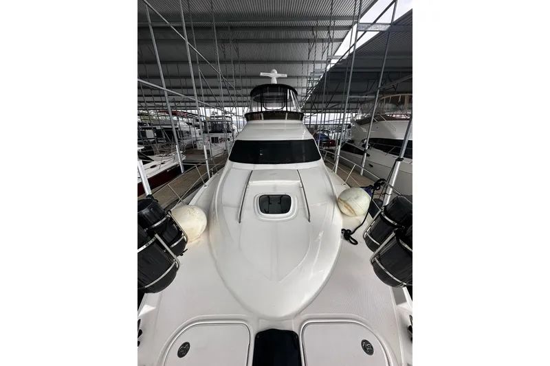 Slide: The Image of 2005 Sea Ray 420 Sedan Bridge yacht docked in a covered marina. - 4