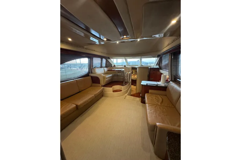 Slide: The Image of Luxurious interior of 2005 Sea Ray 420 Sedan Bridge yacht with leather seating and panoramic windows. - 6