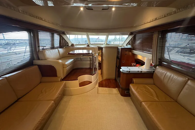 Slide: The Image of Luxurious interior of 2005 Sea Ray 420 Sedan Bridge yacht with leather seating and dining area. - 8