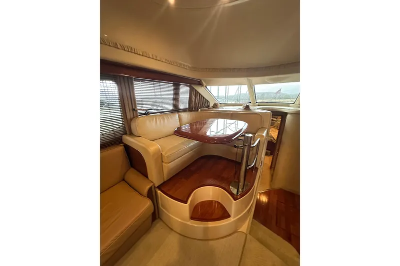 Slide: The Image of Luxurious interior of 2005 Sea Ray 420 Sedan Bridge yacht with elegant seating and table. - 9