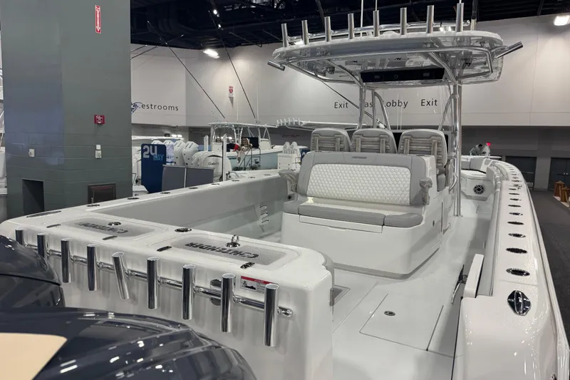Slide: The Image of 2026 Contender 39 ST boat interior at a showroom, featuring sleek seating and modern design. - 12