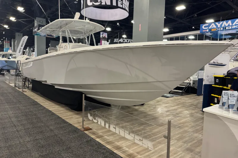 Slide: The Image of 2026 Contender 39 ST boat displayed at an indoor exhibition, showcasing sleek design. - 15