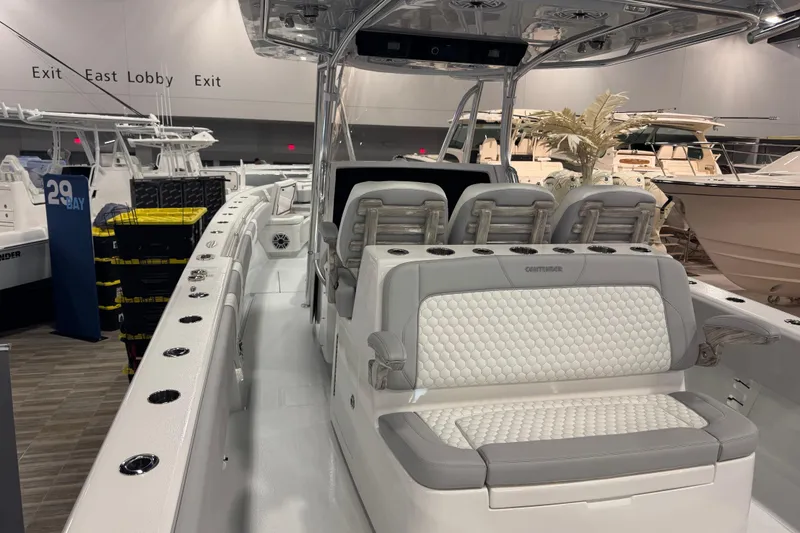 Slide: The Image of 2026 Contender 39 ST boat interior with luxurious seating at a boat show. - 20