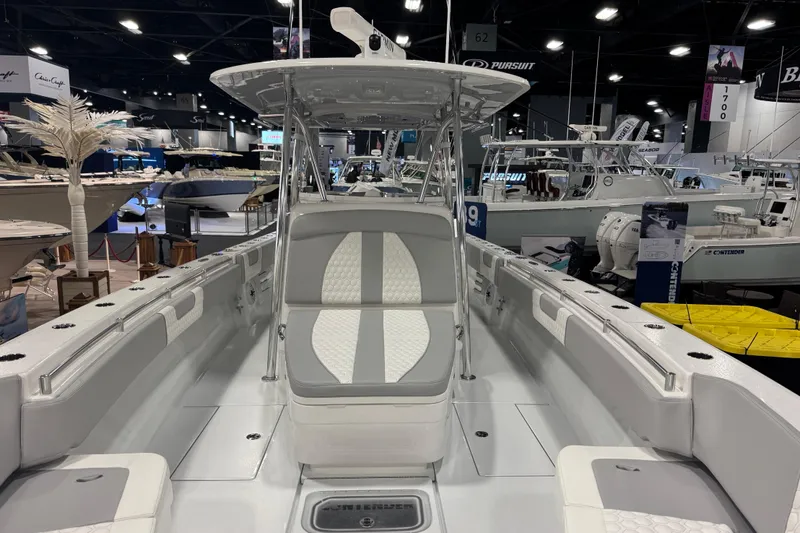 Slide: The Image of 2026 Contender 39 ST boat interior at a boat show, showcasing sleek design and seating. - 21