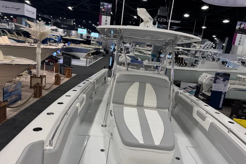 Slide: The Image of 2026 Contender 39 ST boat displayed at a boat show, featuring sleek design and modern amenities. - 24