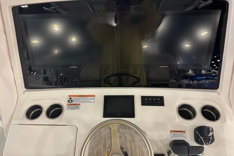 Slide: The Image of 2026 Contender 39 ST boat dashboard with dual Garmin displays and steering wheel. - 27