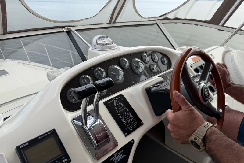 Slide: The Image of Helm of 1996 Sea Ray 420 Aft Cabin with gauges and steering wheel. - 13