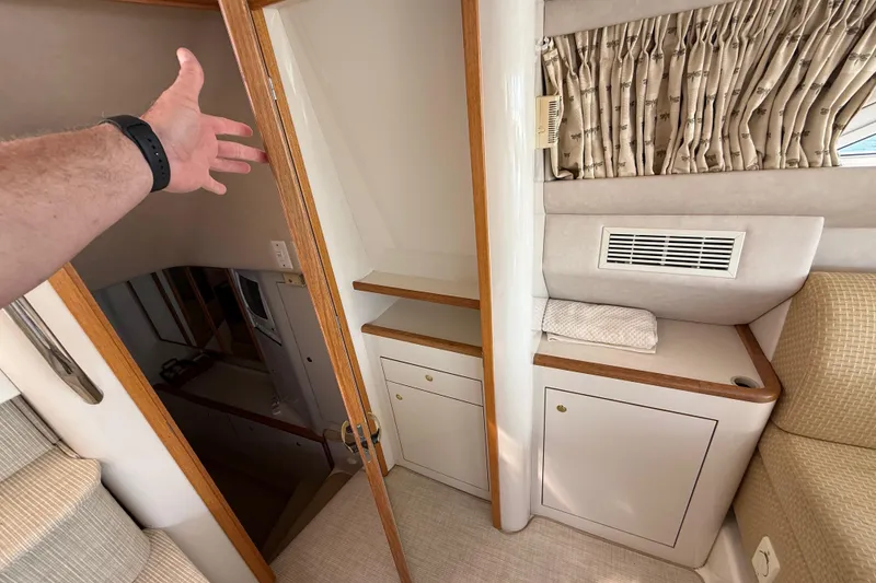 Slide: The Image of Interior of 1996 Sea Ray 420 Aft Cabin with wooden accents and storage space. - 20