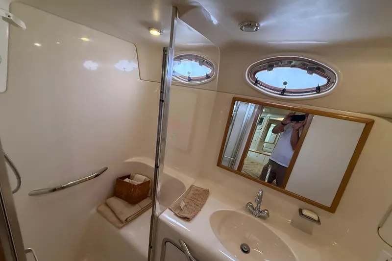 Slide: The Image of Bathroom interior of 1996 Sea Ray 420 Aft Cabin yacht with sink and mirror. - 25