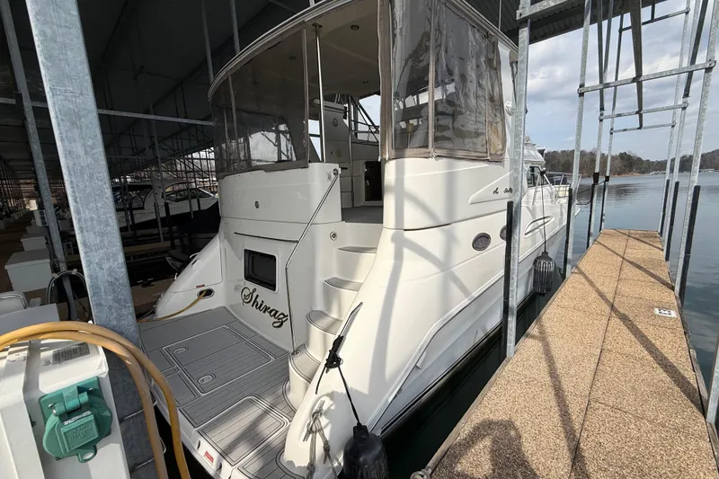 Slide: The Image of 1996 Sea Ray 420 Aft Cabin yacht docked in a marina, side view. - 3