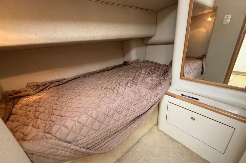 Slide: The Image of 1996 Sea Ray 420 Aft Cabin interior with cozy bed and mirror. - 30