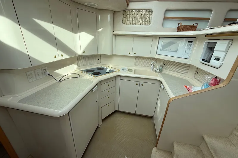 Slide: The Image of 1996 Sea Ray 420 Aft Cabin kitchen with modern appliances and ample storage. - 31