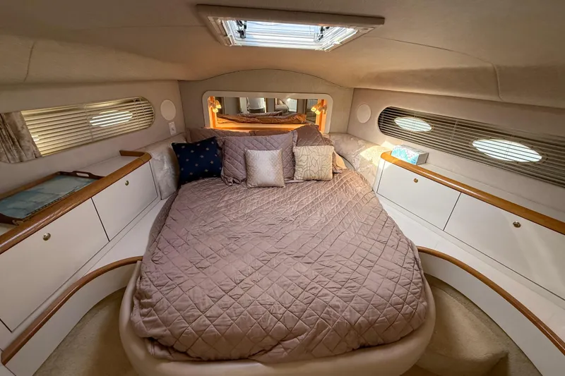 Slide: The Image of Luxurious 1996 Sea Ray 420 Aft Cabin bedroom with cozy bedding and elegant decor. - 33