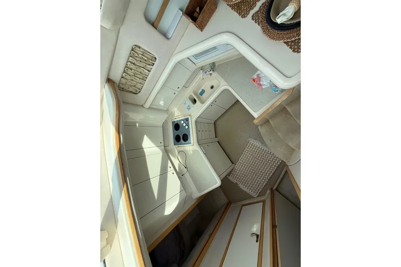 Slide: The Image of Interior of 1996 Sea Ray 420 Aft Cabin yacht, featuring compact kitchen area. - 35