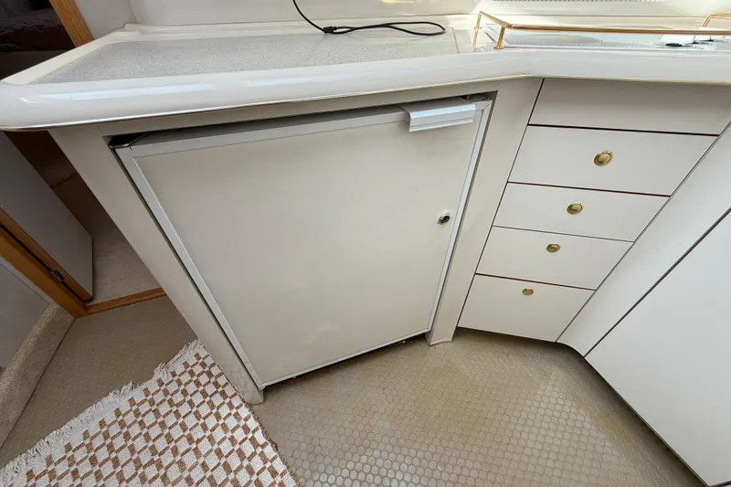 Slide: The Image of 1996 Sea Ray 420 Aft Cabin kitchen with fridge and drawers. - 36