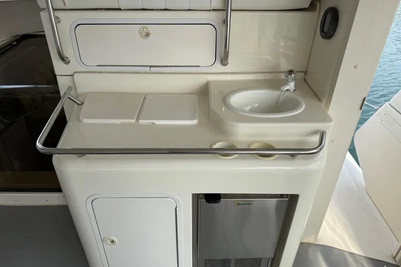 Slide: The Image of 1996 Sea Ray 420 Aft Cabin yacht kitchenette with sink and storage. - 4