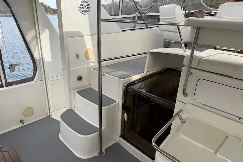 Slide: The Image of 1996 Sea Ray 420 Aft Cabin interior with stairs and seating area. - 6