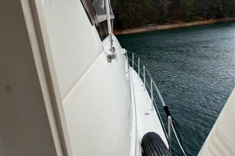 Slide: The Image of 1996 Sea Ray 420 Aft Cabin yacht on calm water, side view. - 7