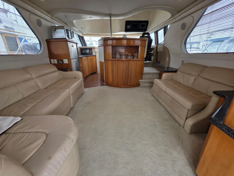 Slide: The Image of Luxurious interior of 2000 Carver 450 Voyager Pilothouse with beige leather seating and wood accents. - 19