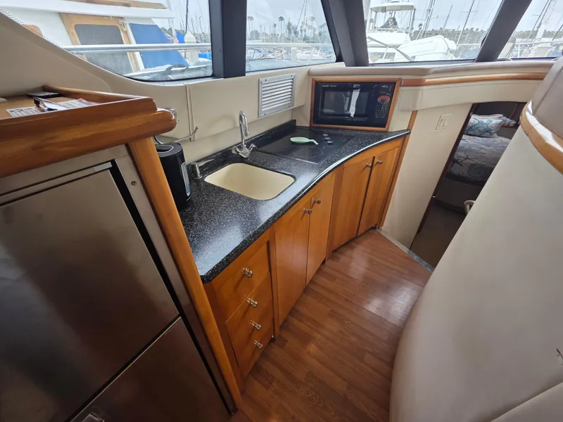 Slide: The Image of Interior of 2000 Carver 450 Voyager Pilothouse with kitchenette, sink, and microwave. - 24