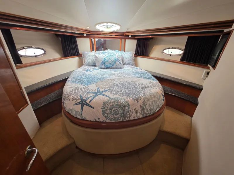 Slide: The Image of Luxurious bedroom in 2000 Carver 450 Voyager Pilothouse yacht with nautical-themed bedding. - 25