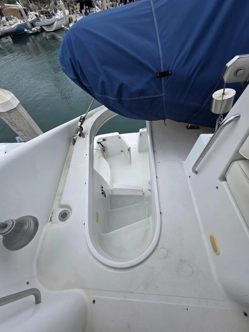 Slide: The Image of 2000 Carver 450 Voyager Pilothouse yacht with covered seating area and marina view. - 36