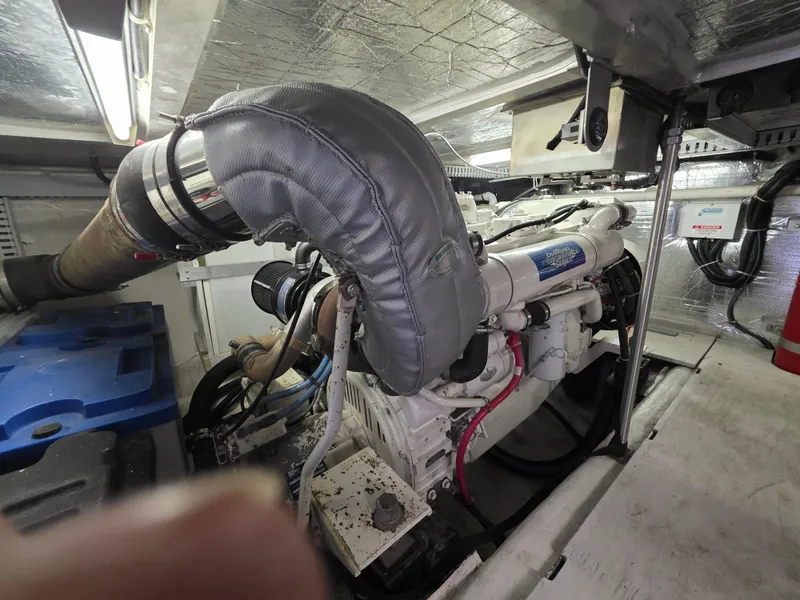 Slide: The Image of Engine room of 2000 Carver 450 Voyager Pilothouse with visible machinery and components. - 42