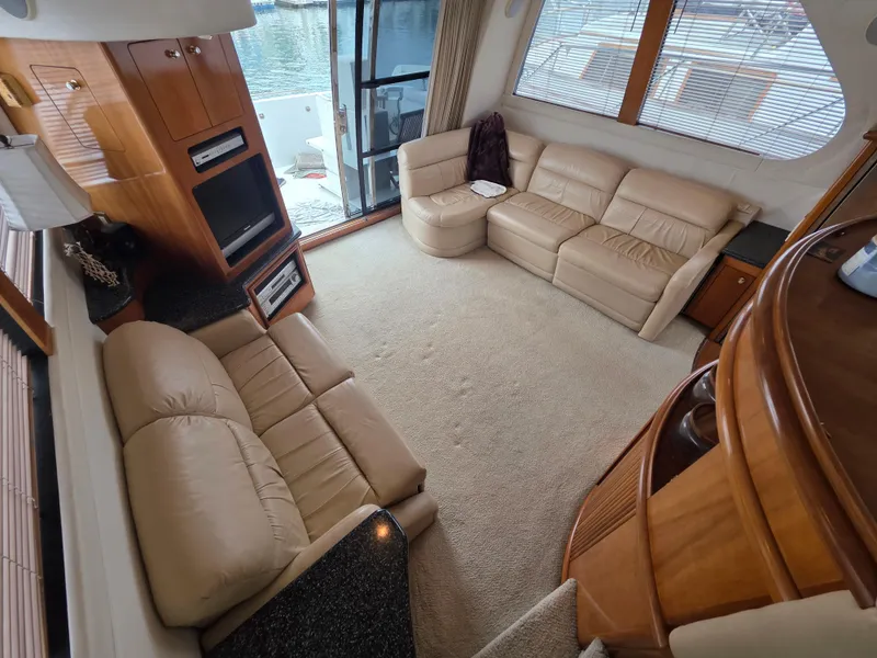 Slide: The Image of Luxurious interior of 2000 Carver 450 Voyager Pilothouse with beige leather seating. - 20