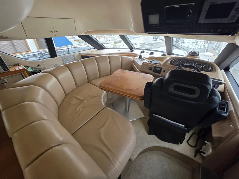 Slide: The Image of Luxurious interior of 2000 Carver 450 Voyager Pilothouse with leather seating and helm. - 21