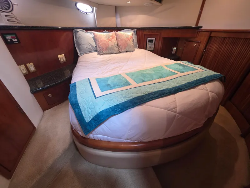 Slide: The Image of Luxurious bedroom in 2000 Carver 450 Voyager Pilothouse yacht with cozy bedding. - 29