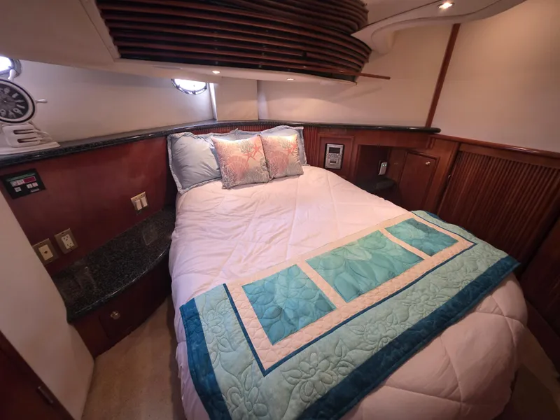 Slide: The Image of Luxurious bedroom interior of 2000 Carver 450 Voyager Pilothouse yacht with cozy bedding. - 30
