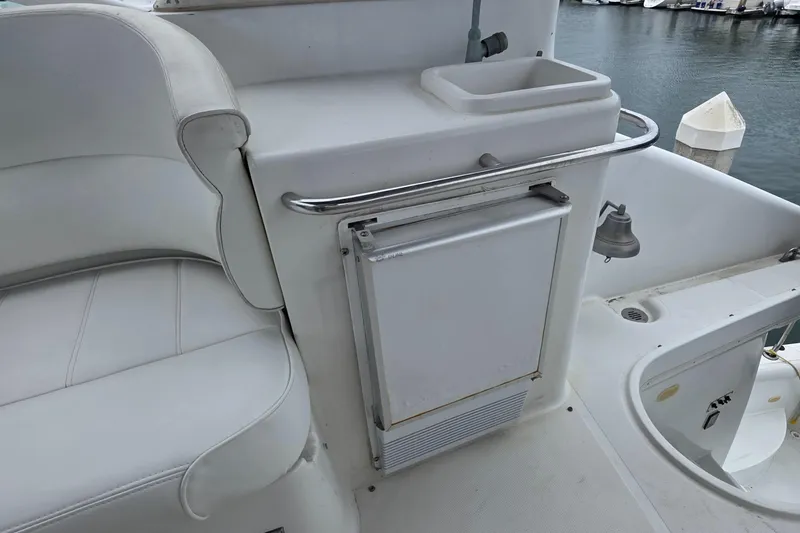 Slide: The Image of 2000 Carver 450 Voyager Pilothouse yacht interior with seating and mini fridge. - 37