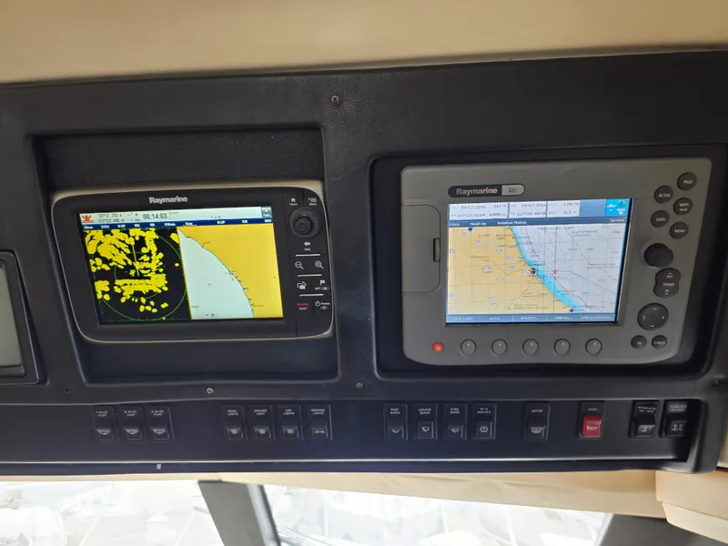 Slide: The Image of Carver 450 Voyager Pilothouse 2000 dashboard with navigation screens and controls. - 38