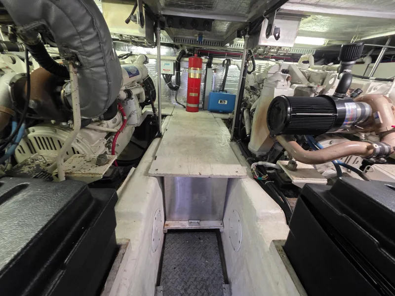 Slide: The Image of Engine room of a 2000 Carver 450 Voyager Pilothouse with visible machinery and fire extinguisher. - 41