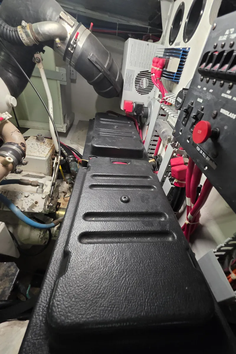 Slide: The Image of Engine room of 2000 Carver 450 Voyager Pilothouse with visible components and wiring. - 47