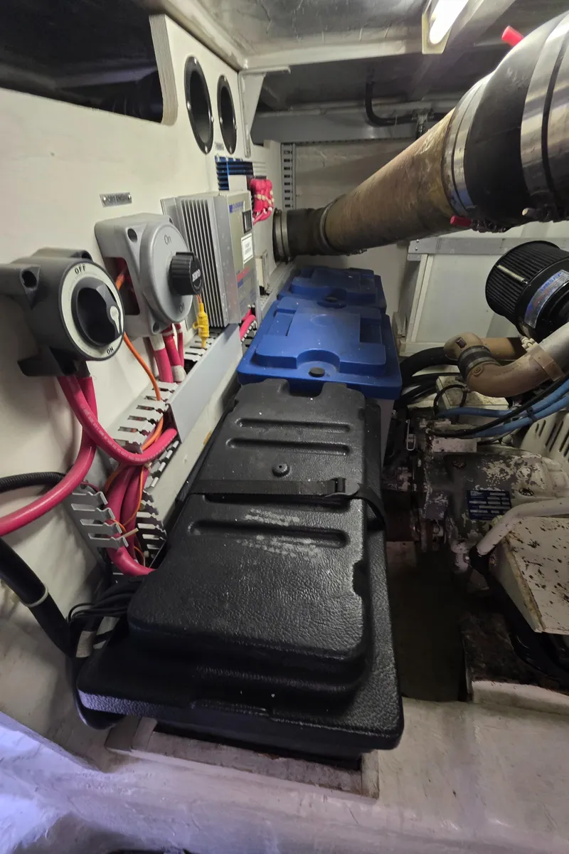 Slide: The Image of Engine room of 2000 Carver 450 Voyager Pilothouse with visible components and wiring. - 48