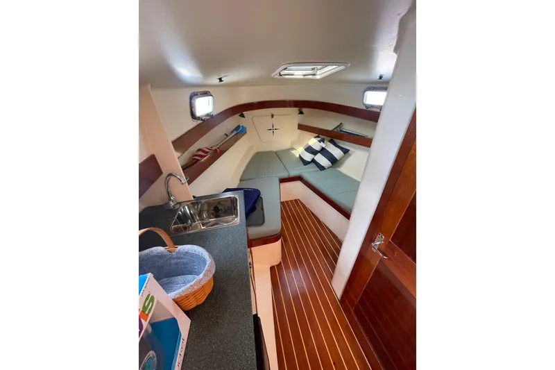 Slide: The Image of Interior of 2009 Landing School Arrundel 27 sailboat with cozy seating and kitchenette. - 13