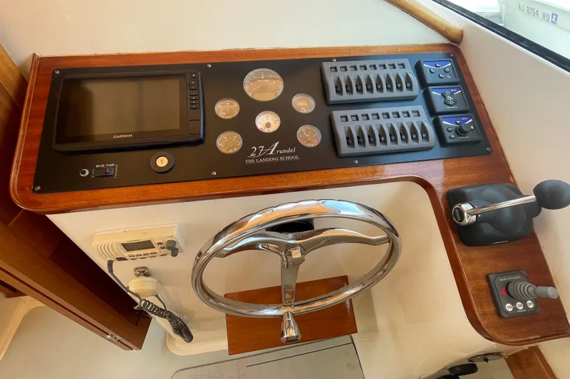 Slide: The Image of Control panel of 2009 Landing School Arrundel 27 boat with steering wheel and gauges. - 16