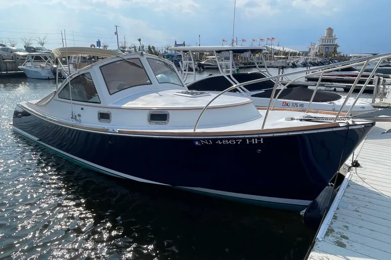 Slide: The Image of 2009 Landing School Arrundel 27 boat docked at marina, sunny day. - 2